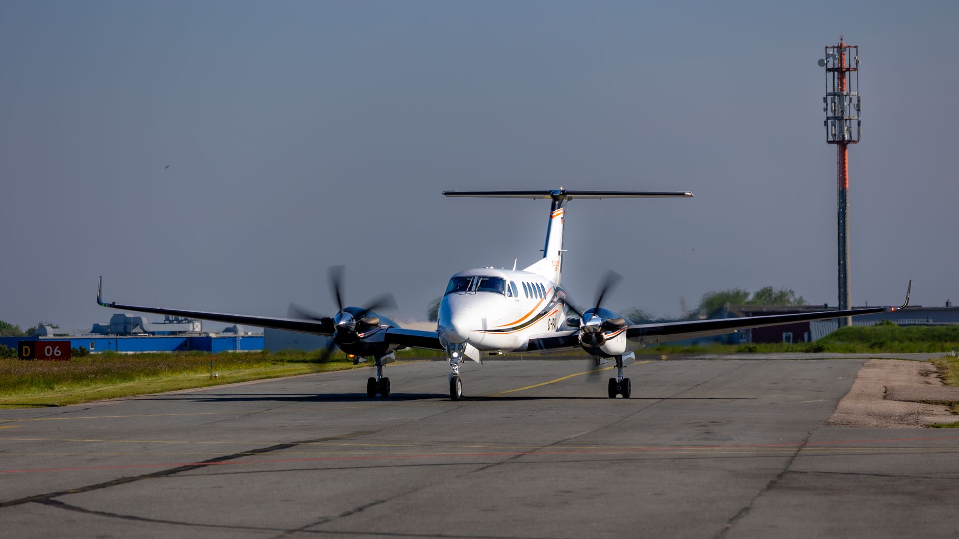 A small propeller aircraft taxiing on an airport apron under a dark sky (illustrative stock photo).